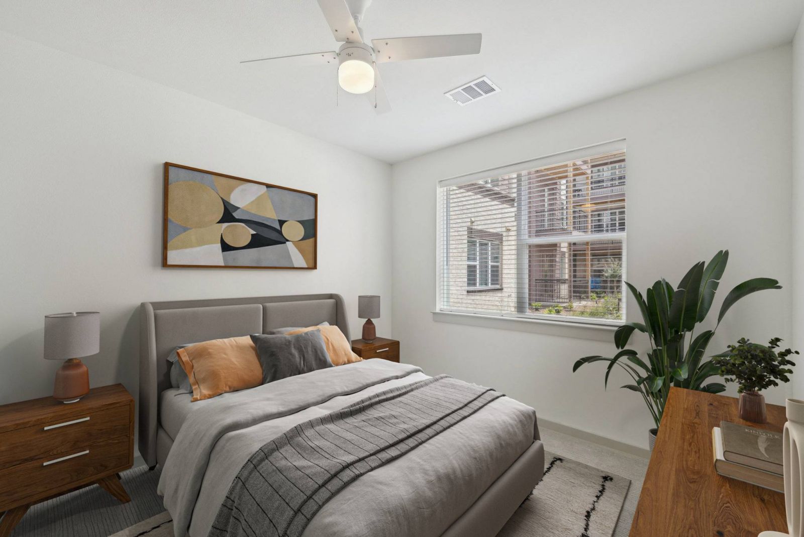 Meridian at Wylie Modern bedroom with gray bed, wooden furniture, a large window, and decorative artwork above the headboard.